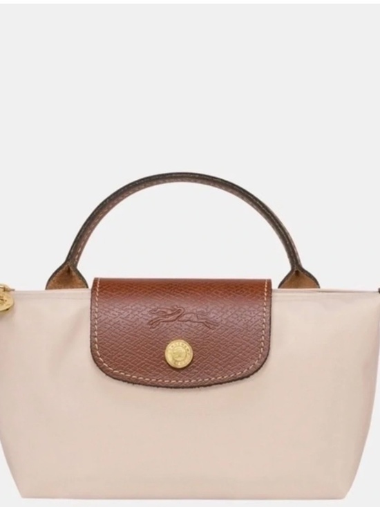 Longchamp Handbags - Compact cream nylon mini tote. Brown leather flap and top handle. Gold-tone butt